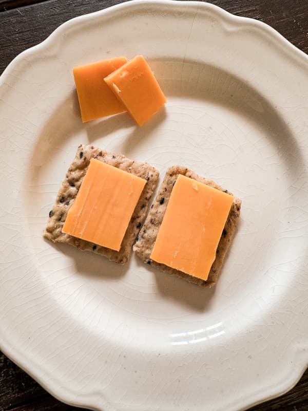 Smoke Sharp Cheddar cheese on crackers .