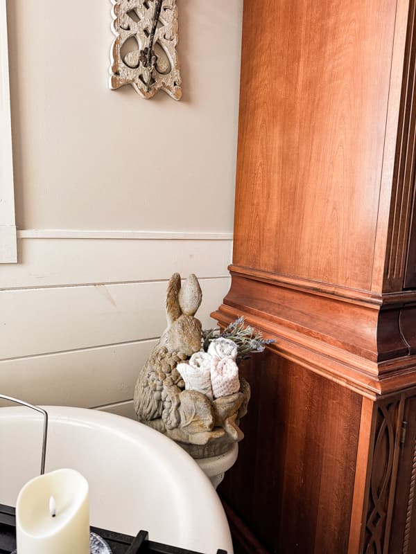 Concrete bunny planters with bath towels beside bath tub