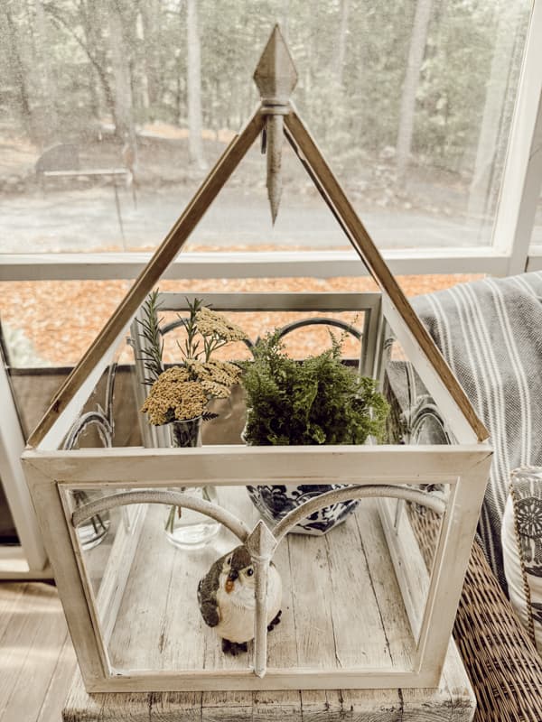 DIY Glass Terrarium with plants made from Thrifted Stool and Dollar Tree Picture Frames and Garden Fence.