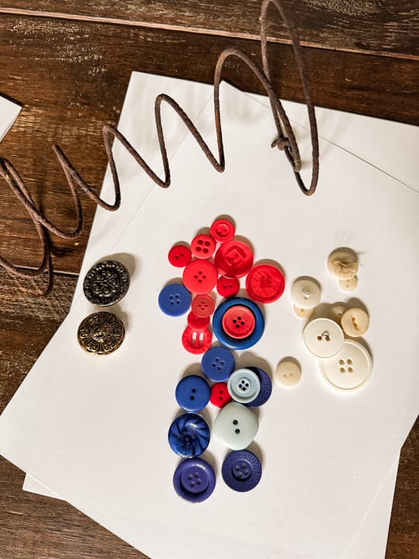 red, white, and blue buttons with old mattress spring and white card stock paper