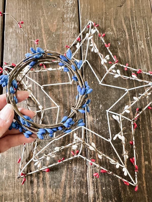 Add red, white and blue beaded garland to make a patriotic wreath with a  frame from Dollar Tree