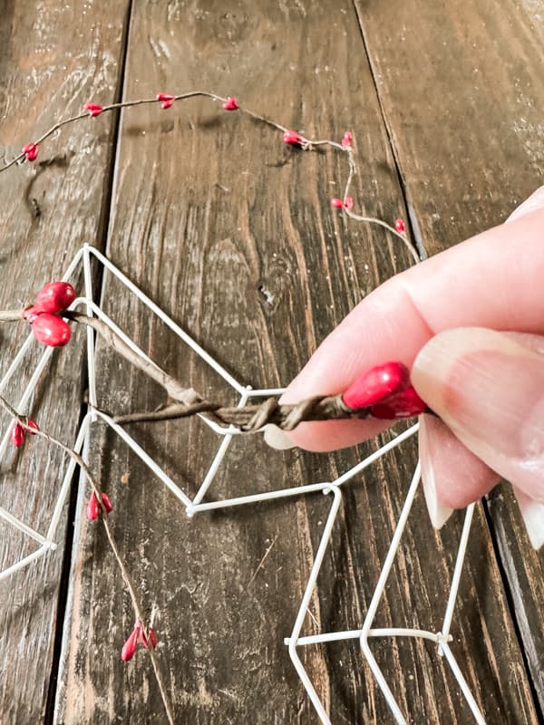 Wrap red beaded garland around star frame with Dollar tree supplies. 