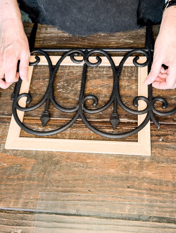 Measure Dollar Tree garden fence to the wooden frame and cut accordingly.  