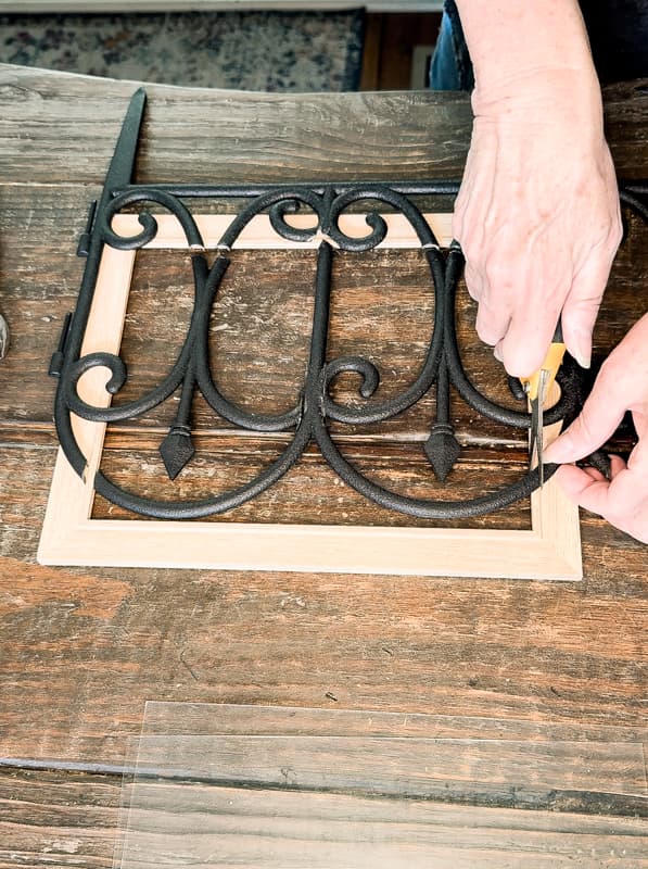 Measure Dollar Tree garden fence to the wooden frame and cut accordingly.  