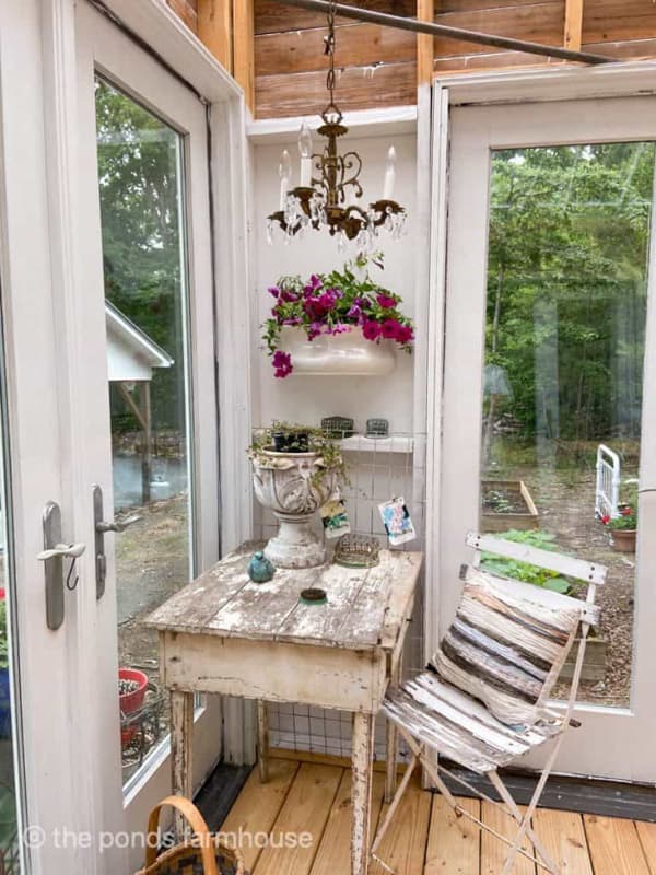 greenhouse vintage desk, free chandelier, and ironstone planter with petunias