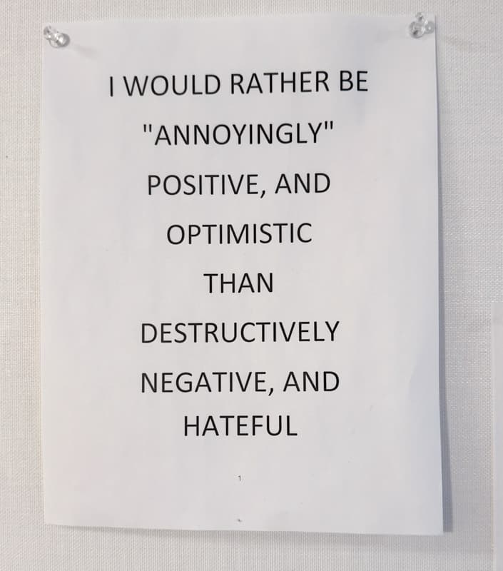 Note on office wall about positive