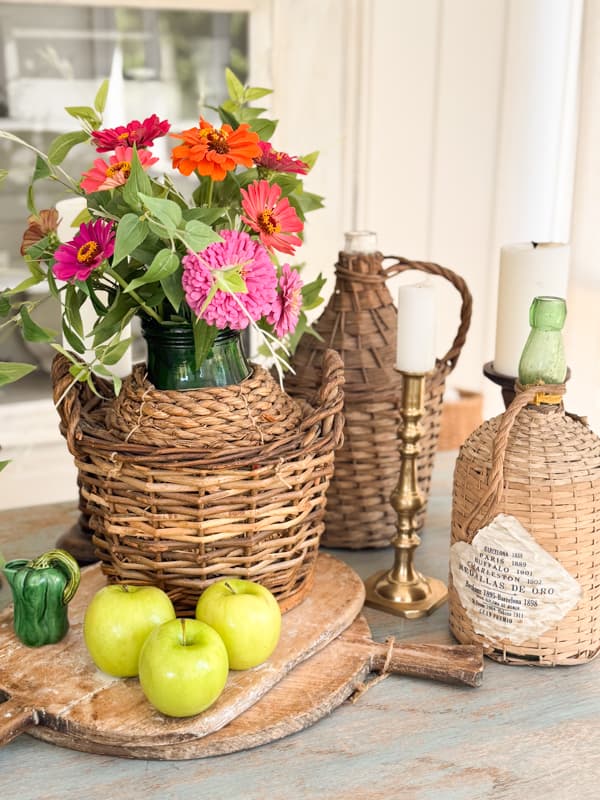 3 vintage demijohns on dining table 