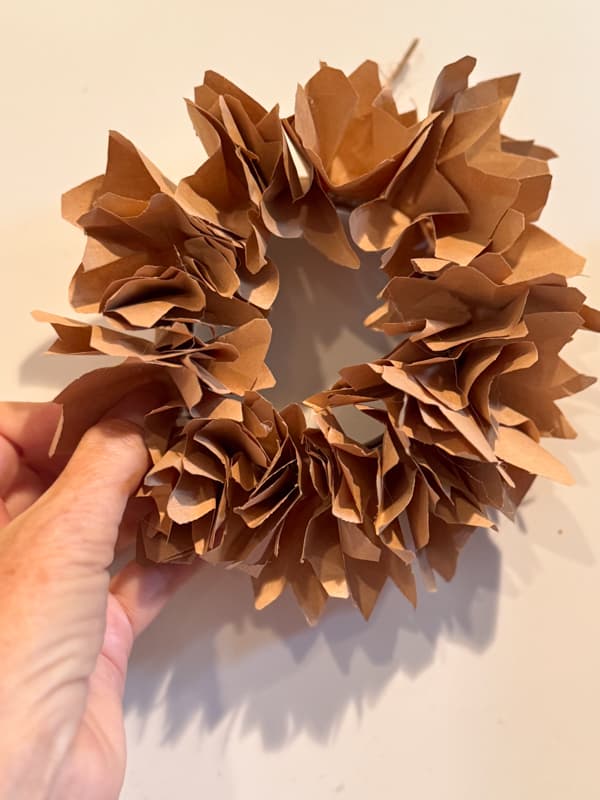 fluff the faux corn husks to shape the mini wreaths