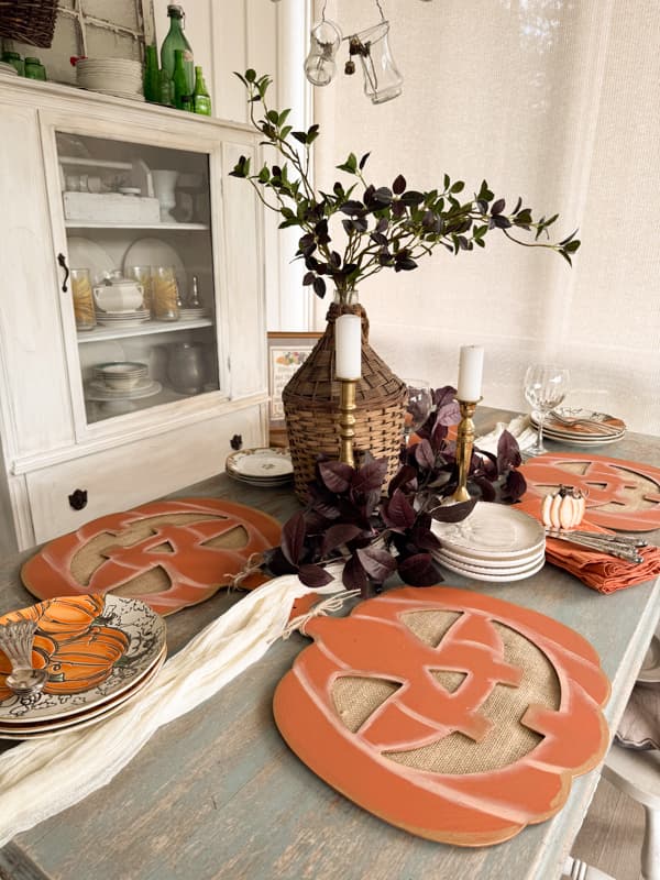 Table with Jack-o-lantern placemats made with Dollar Tree cut-outs