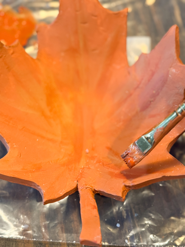 adding darker and lighter paint for a mottled appearance on tray