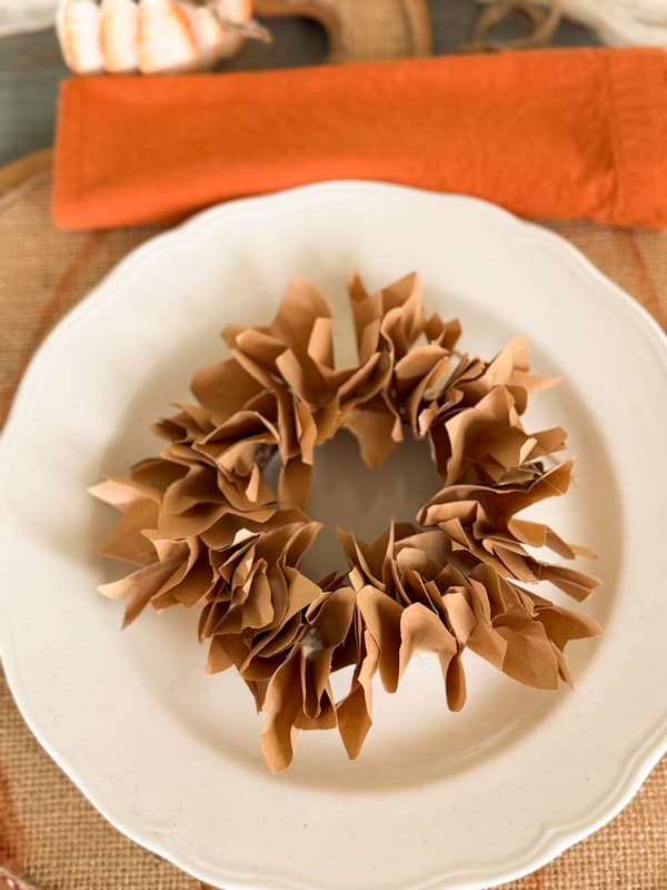 mini wreath in center of dinner plate on fall table