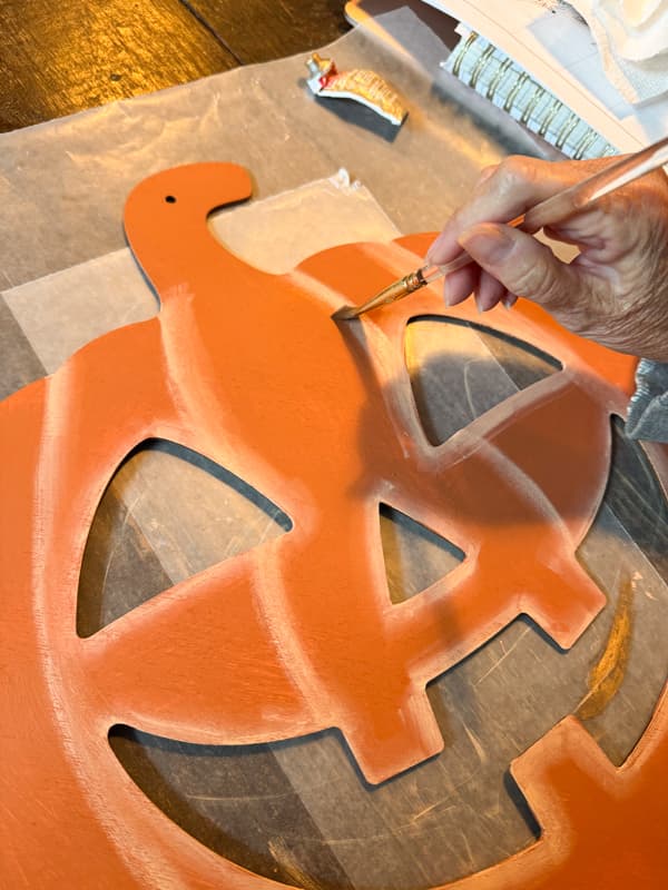 paint details on wood jack o lantern face