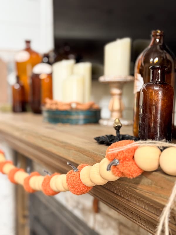 pumpkin and bead garland on mantel