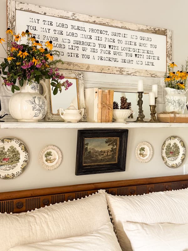 repurposed mantel shelf decorated for fall with mirrors and transferware