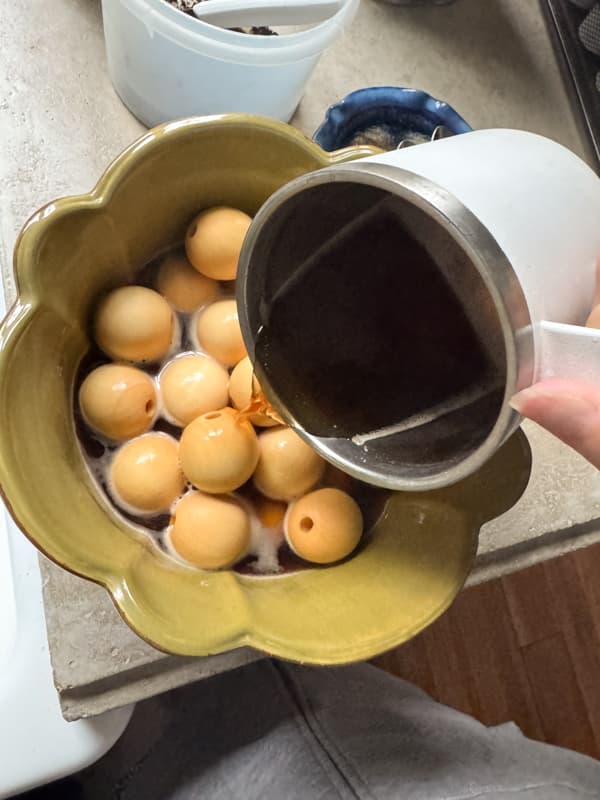 pour coffee over the wood beads to stain