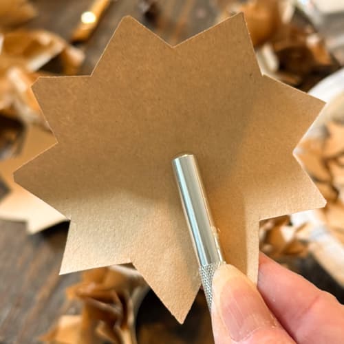 wrap paper around paint brush handle