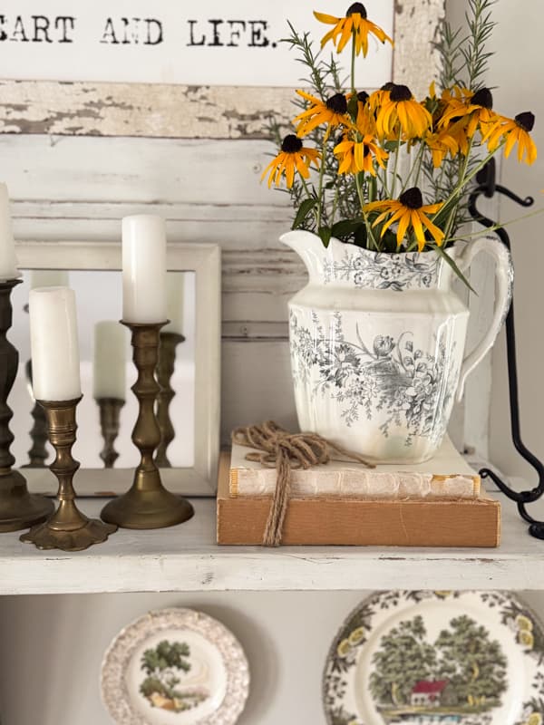 vintage transferware pitcher with black eyed susans on shelf