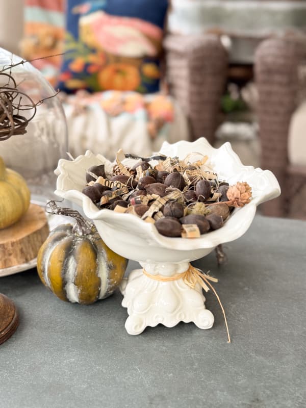 hickory nuts in white pedestal bowl on coffee table