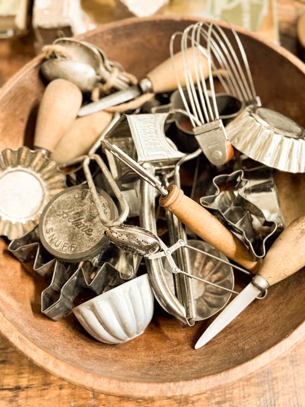 vintage kitchen utensils in vintage wooden bowl