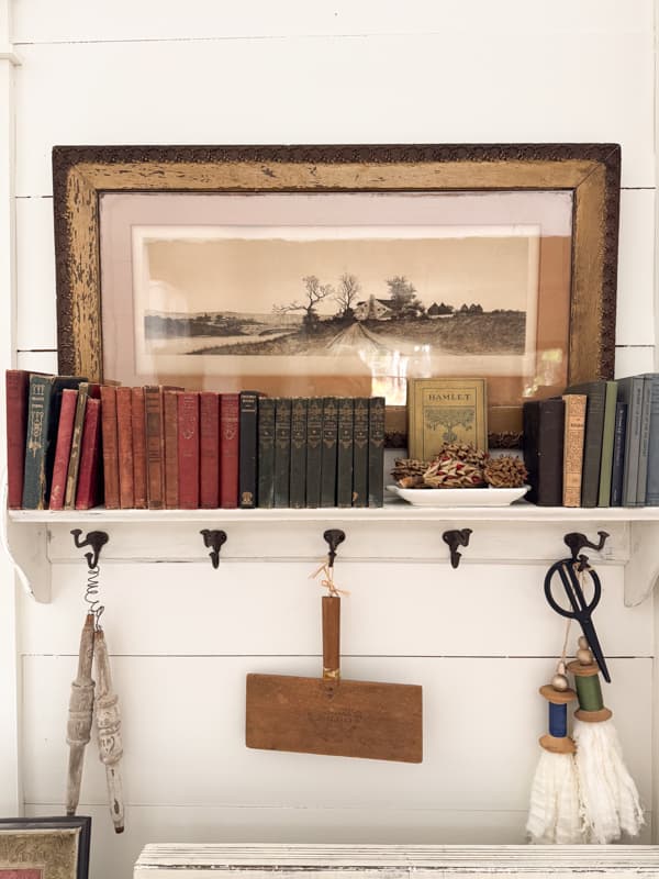 miniature vintage book collection on wall shelf