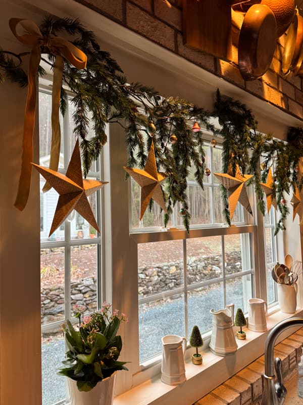 5 paper stars on garland above kitchen window. 