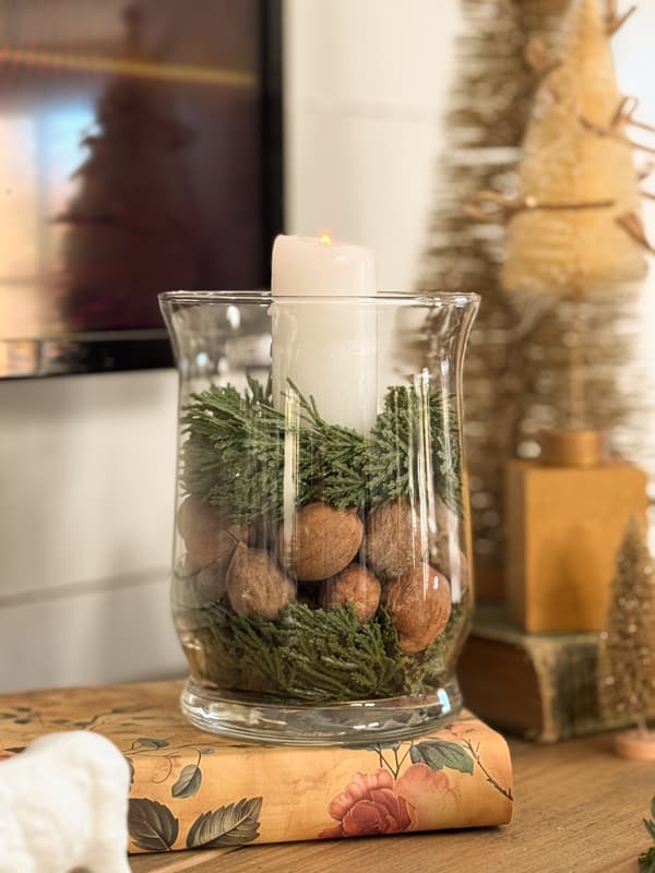 small greenery candlerings with nuts and candle in Dollar Tree Vase