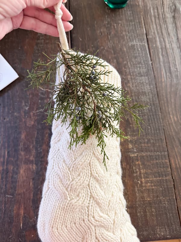 Adding cedar greenery to Christmas Stockings