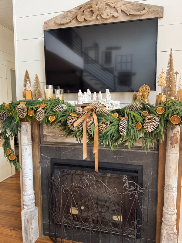 Christmas mantel with pinecones and dried oranges