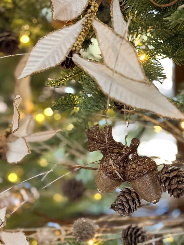 White and gold stems along with pinecones fill the tree