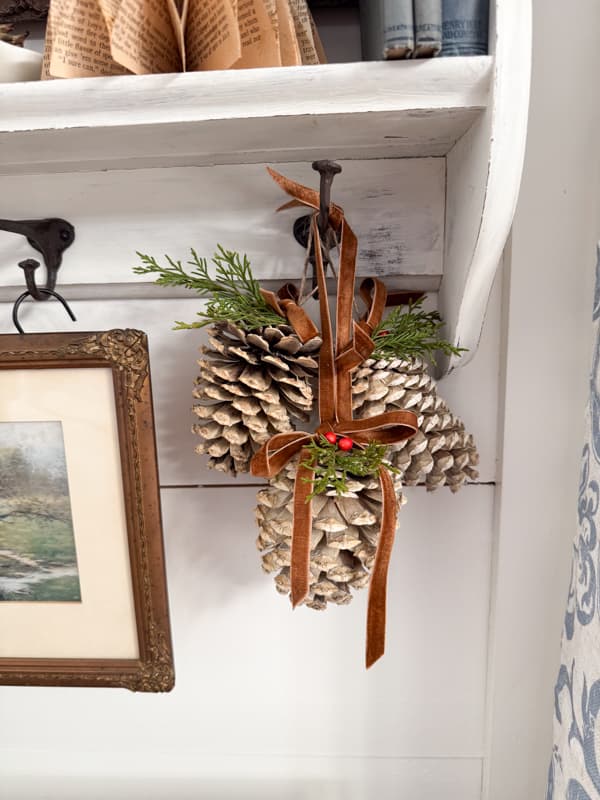DIY bleached pinecones hanging from a shelf