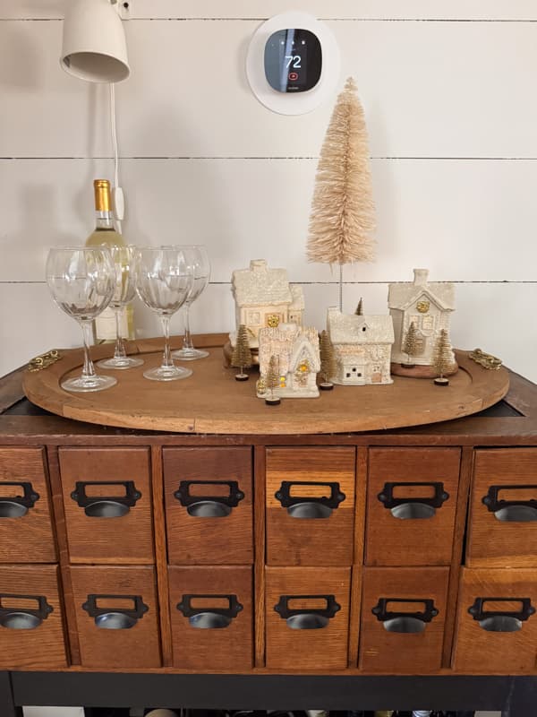 Dining room card catalog wine bar with repurposed old Christmas houses  and wine glasses