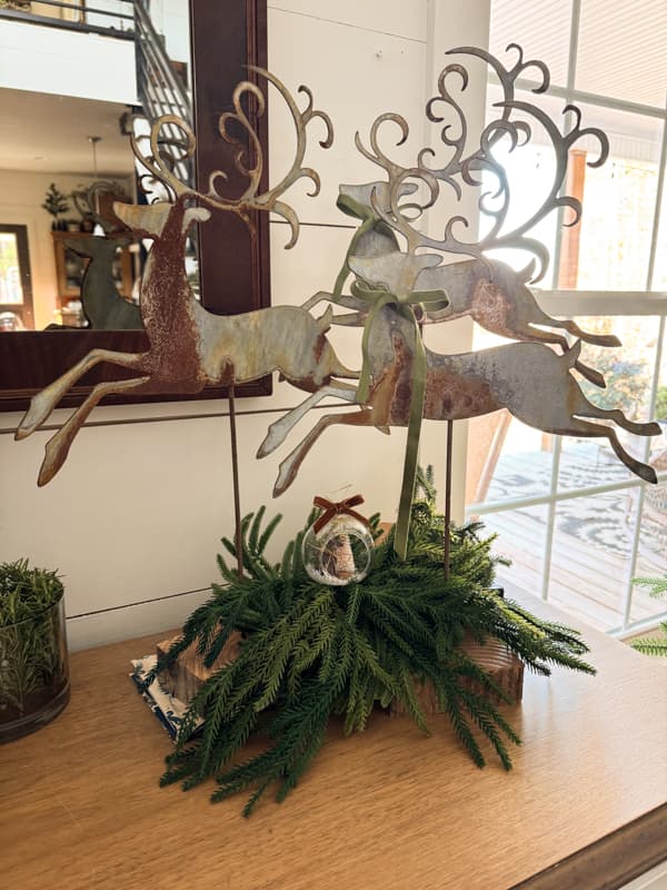 Entry table metal reindeer with greenery and DIY Snow Globe on entry table 2025