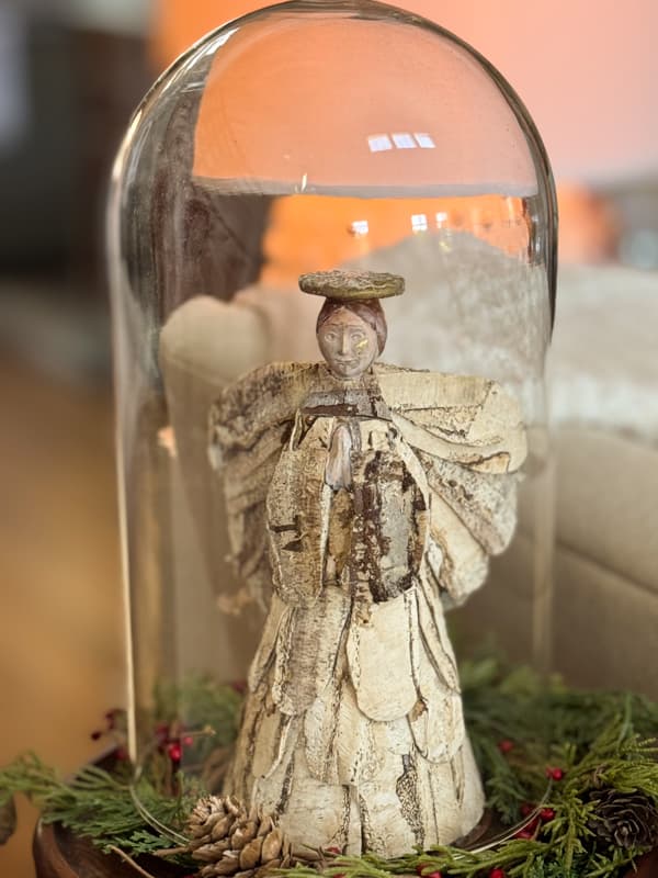 Birch bark covered thrift store angel under glass coche.