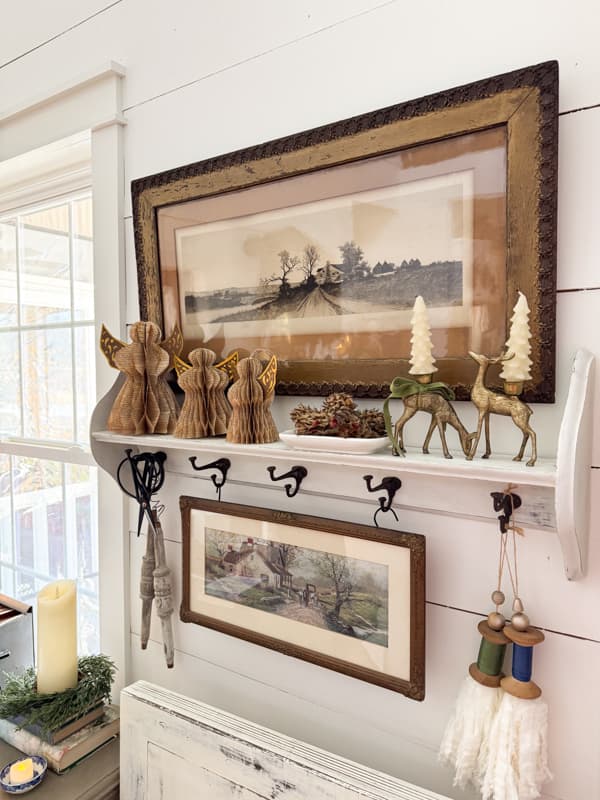 Shelf with DIY old book page angels and vintage art and vintage brass deer candle holders