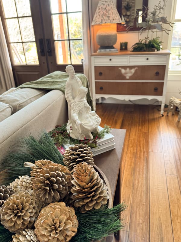 Sofa table with update nativity scene and bleached pinecones
