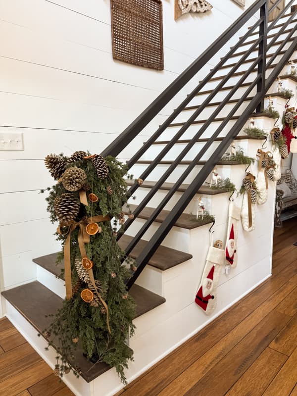 Farmhouse Banister with pinecones and Christmas Stockings