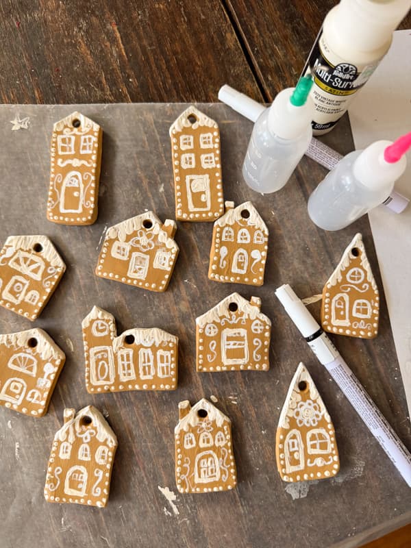 air dry clay gingerbread house ornaments painted with details.