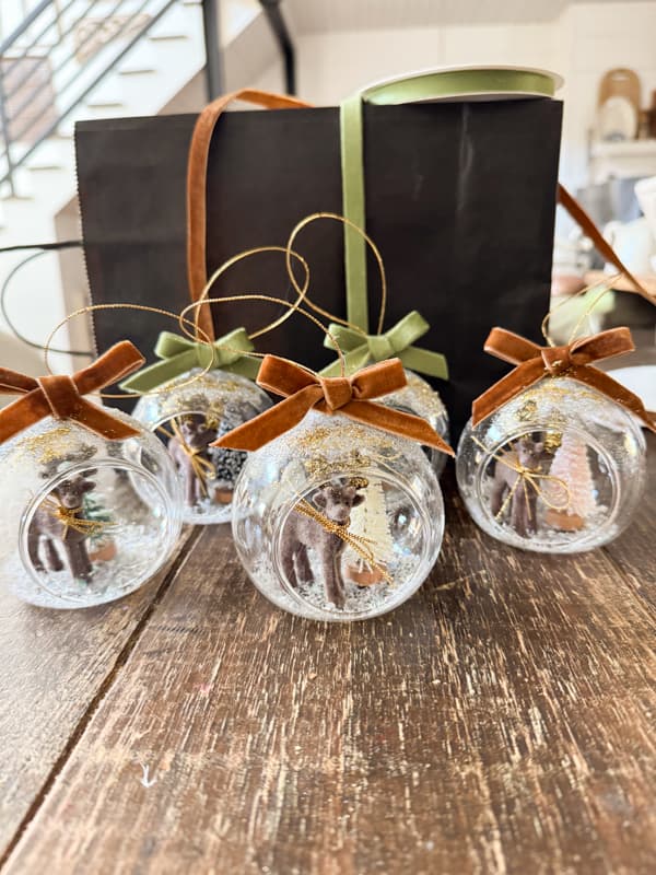 reindeer snow globe ornaments with velvet ribbons