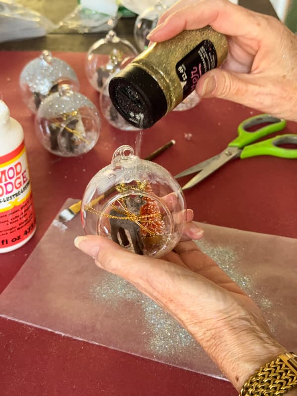 sprinkle to of ornaments with fine glitter