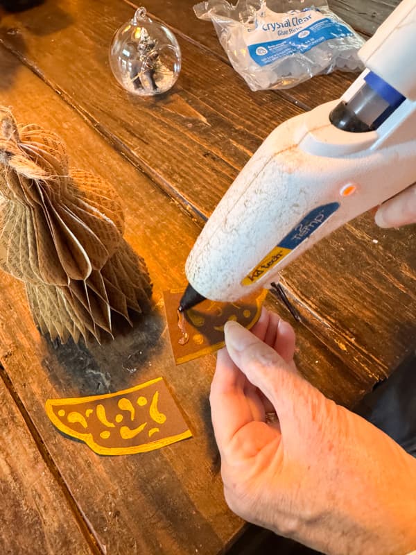 add hot glue to angel wing