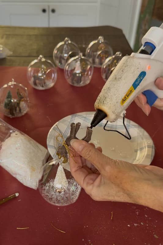 add hot glue to the bottom of each hoof