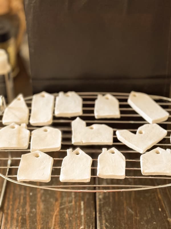 air dry clay gingerbread house ornaments on drying rack. 