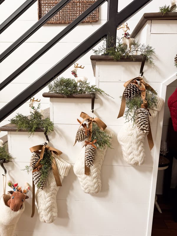 bleached pinecone enhanced Christmas stockings on Staircase