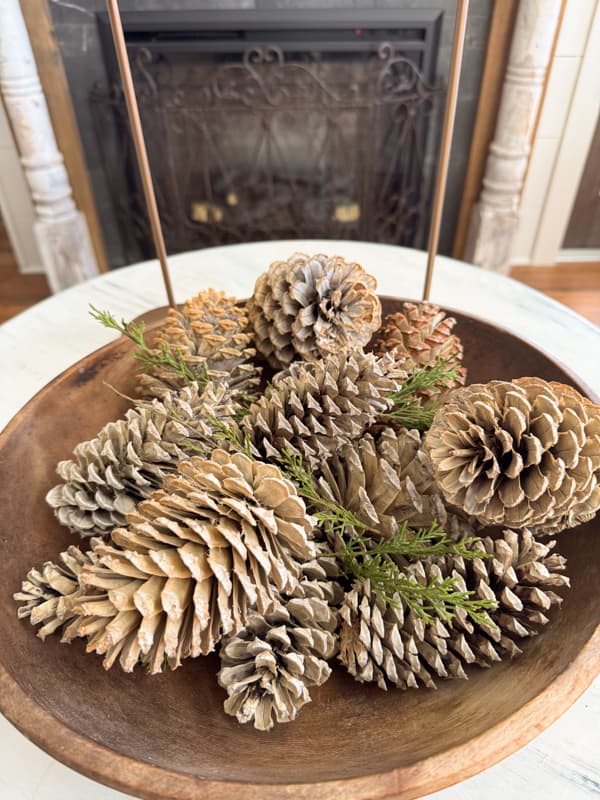 bleached pinecones in large wooden bowl