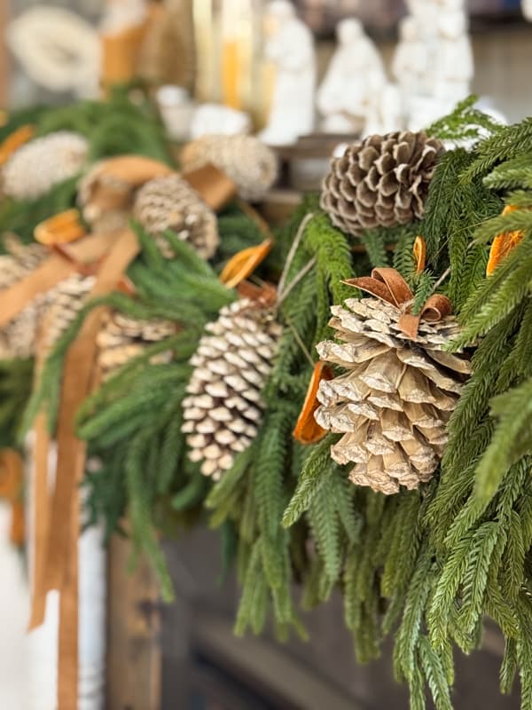 close up of bleached pinecones on mantel garland