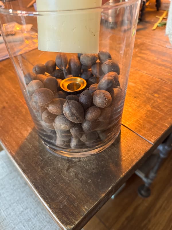 nuts and flicker candle in large vase