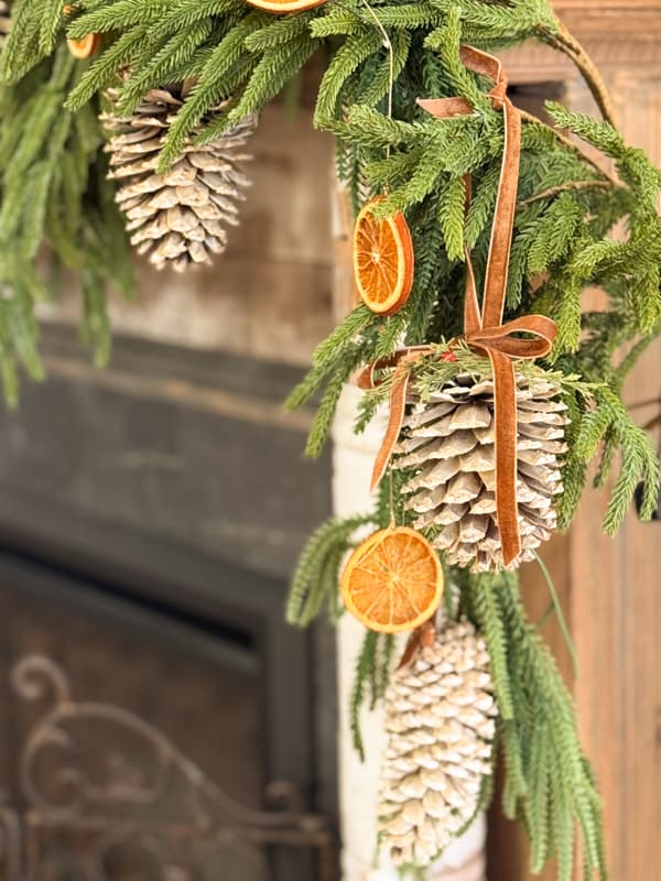 side view of bleached pinecones and dried orange slices on mantel garland
