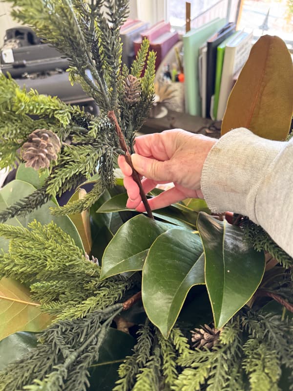 add faux stems to planter arrangement