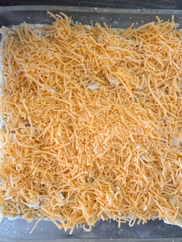 shredded cheese on top of crackers for Broccoli Casserole