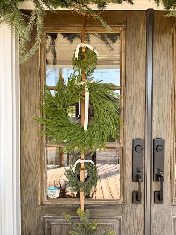 front door with trio of wreath and velvet ribbons